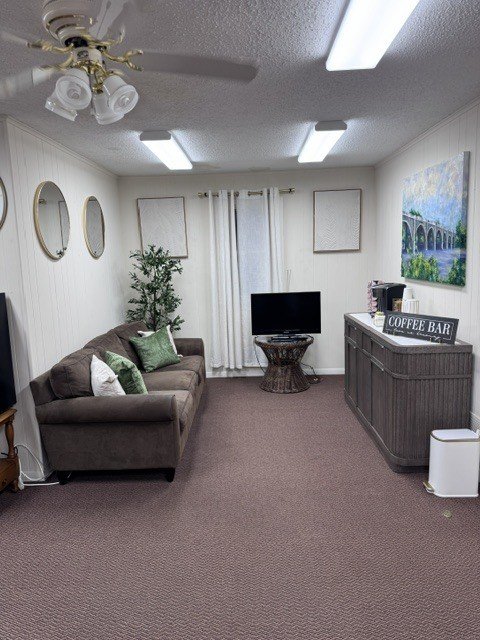The Stackhouse Family Dentistry waiting room with a sofa, a television and a coffee bar